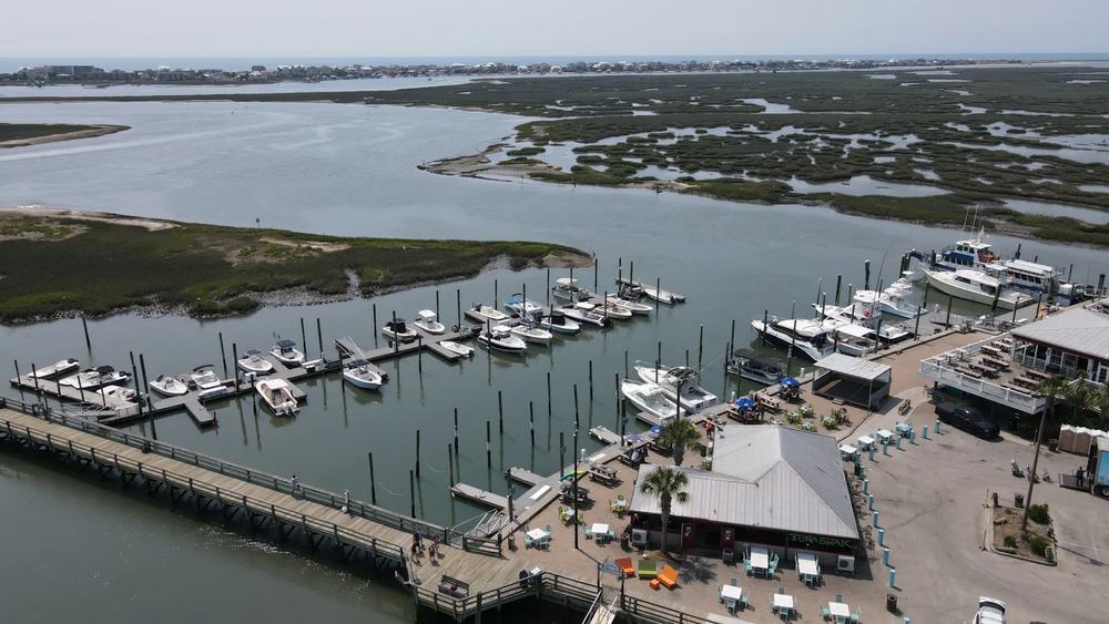 Aerial view of the Murrells Inlet marina and MarshWalk with boats, waterfront restaurants and the marsh beyond